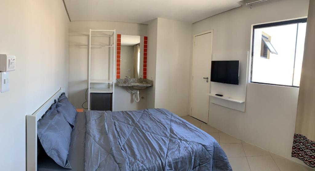 a hospital room with a bed and a television at Senhor Hotel in Juazeiro do Norte