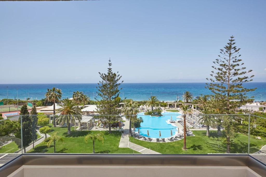 a view of the ocean from the balcony of a resort at Sheraton Rhodes Resort in Ixia