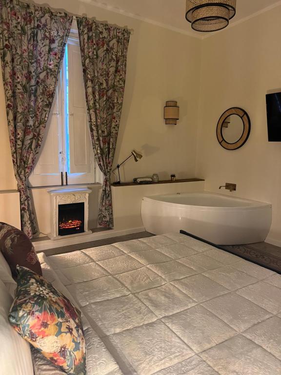 a large bathroom with a tub and a fireplace at Borgo Marinaro Suite in Salerno