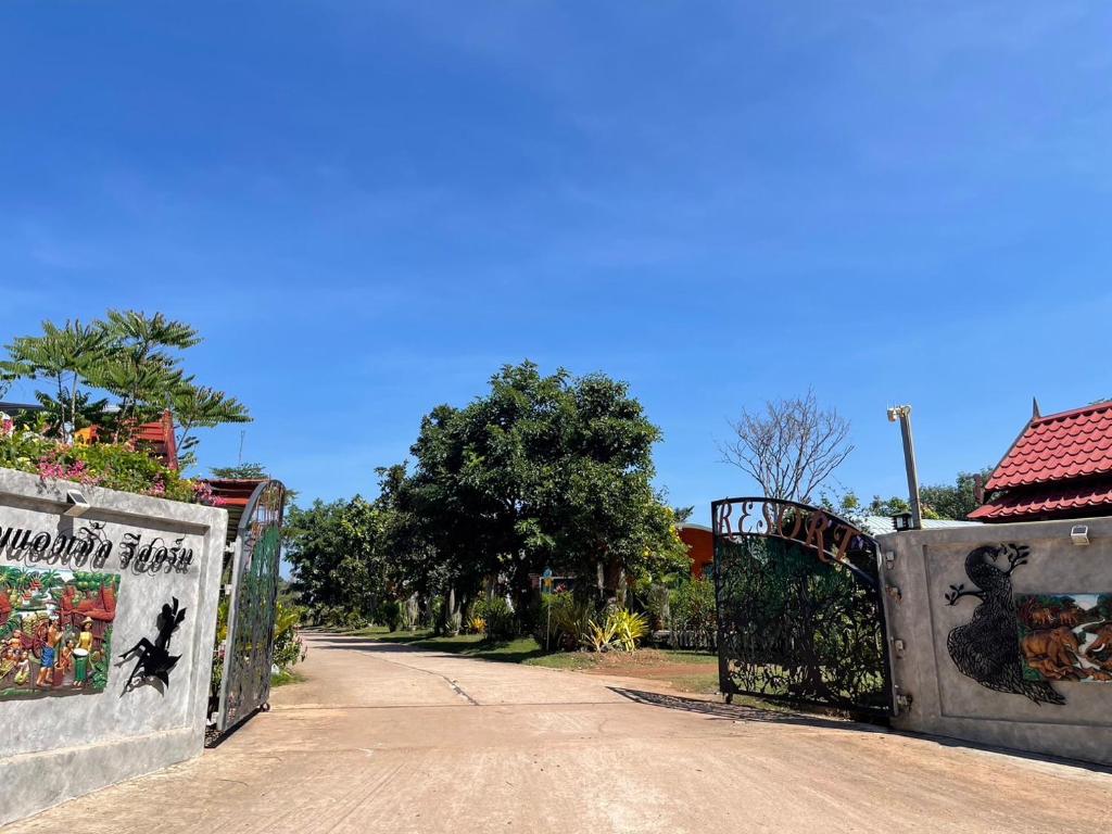 a gate to a driveway in a house at ANGEL RESORT i in Amphoe Sawang Daen Din