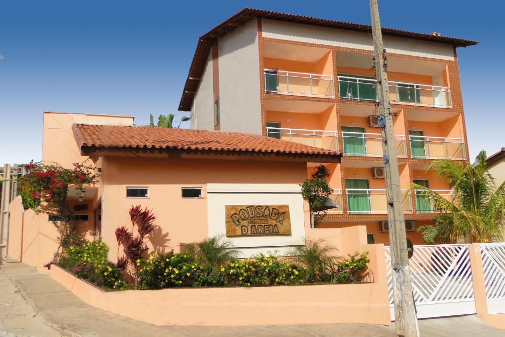 a building with a sign on the side of it at Pousada D' Areia in Barreirinhas