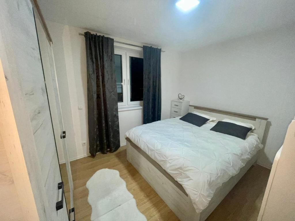 Un pat sau paturi într-o cameră la MURIC Apartman 7