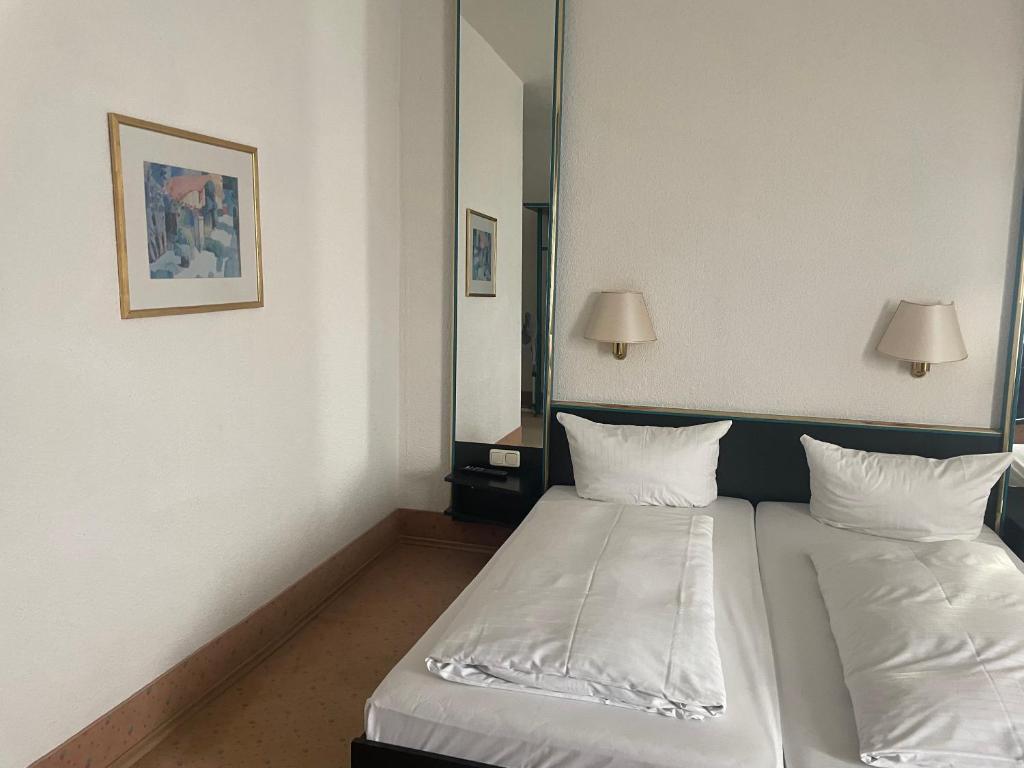 Postel nebo postele na pokoji v ubytování Hotel Bitterfelder Hof
