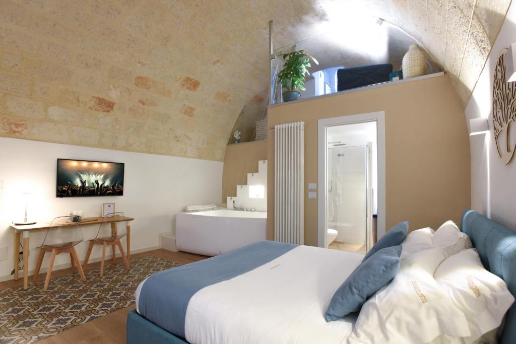 a bedroom with a bed and a table in a room at Maison Chene con vasca idromassaggio in Bisceglie