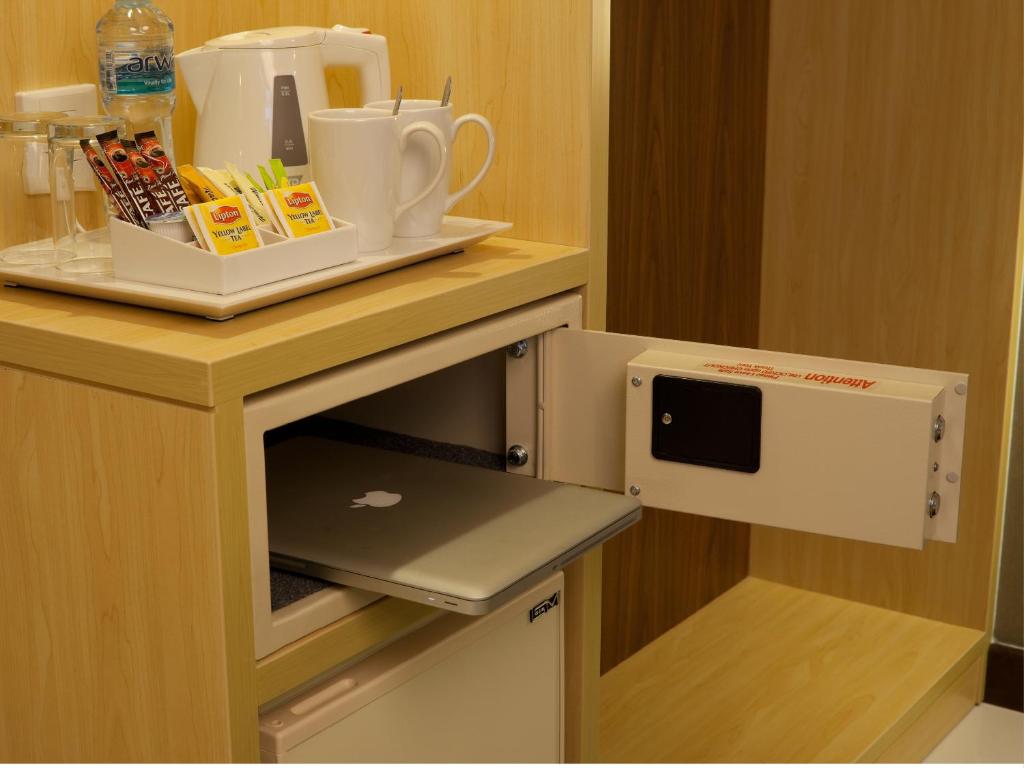 a kitchen with a counter with a microwave oven at Citymax Hotel Bur Dubai in Dubai