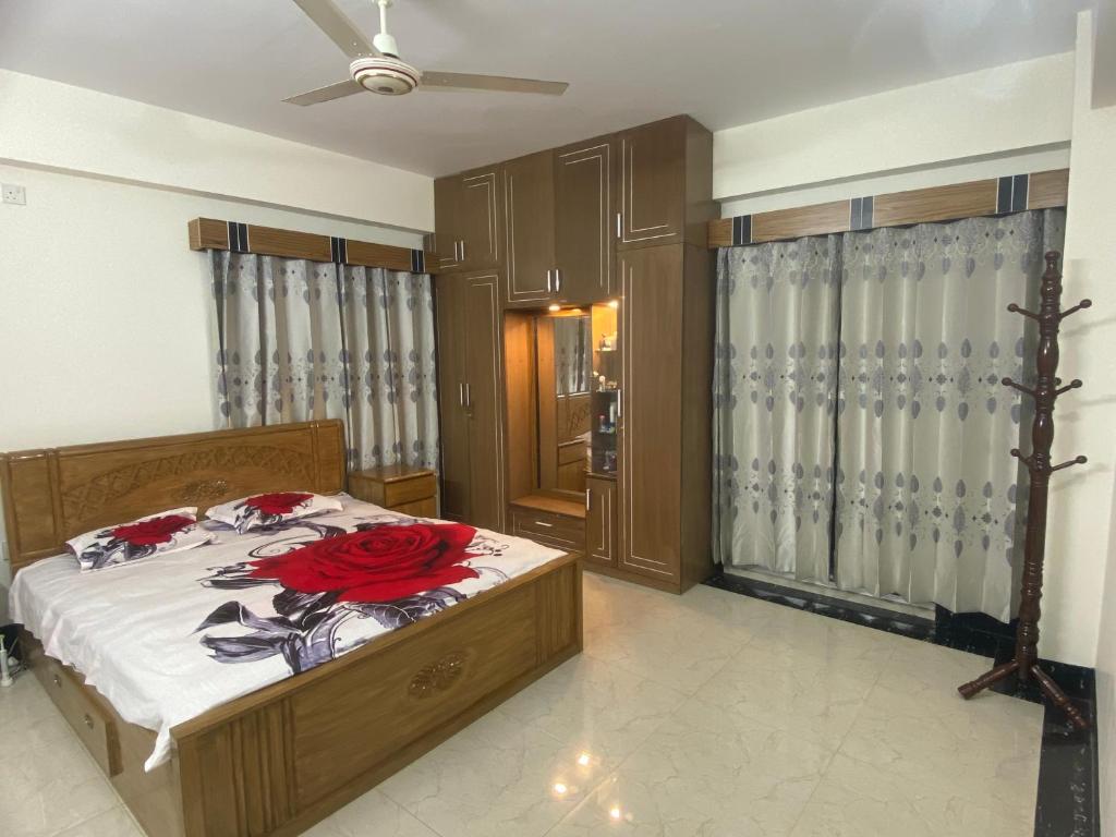 a bedroom with a bed with red roses on it at 3 beds flat in Chittagong in Chittagong