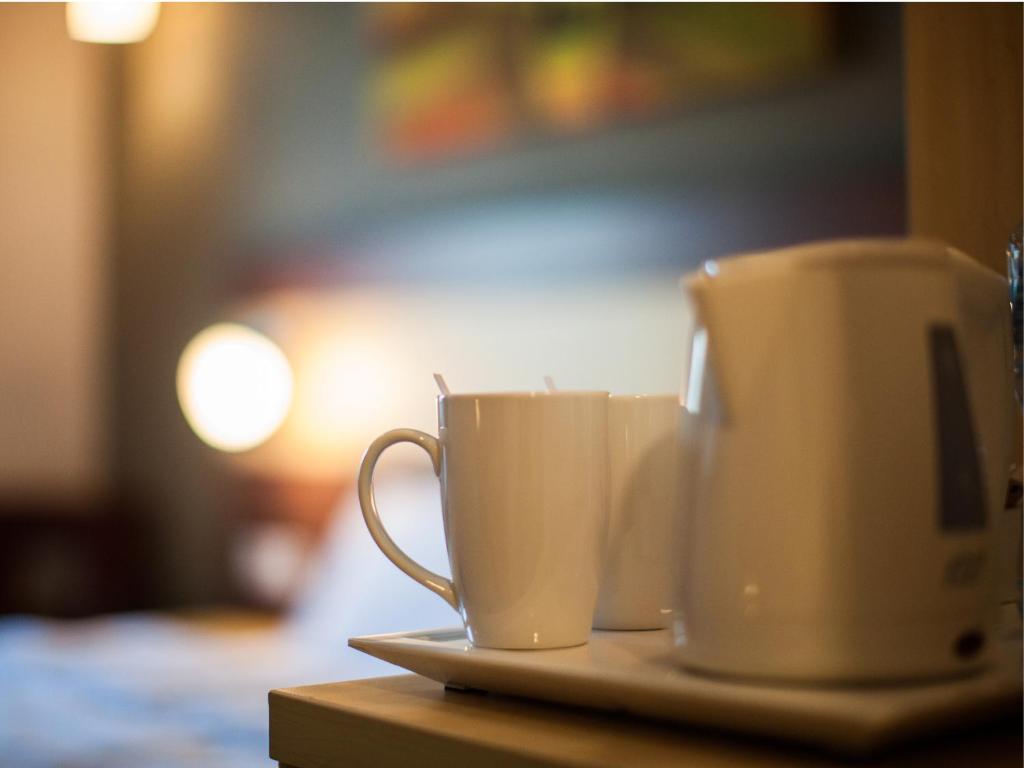 two coffee cups on a plate on a table at Citymax Hotel Bur Dubai in Dubai