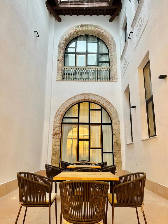 a dining room with a table and chairs at Soho Boutique Cádiz in Cádiz
