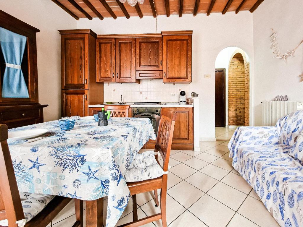 a kitchen with a table with a blue and white table cloth at Casa Veronica Rio Marina in Rio Marina