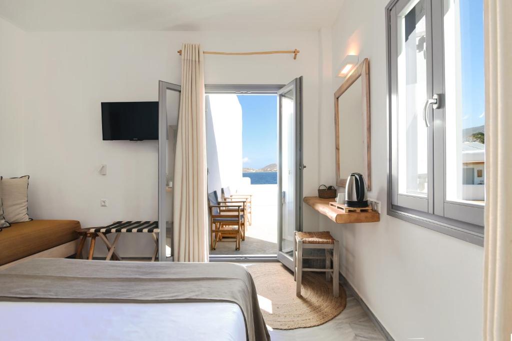 a bedroom with a bed and a view of the ocean at Paros Bay in Parasporos