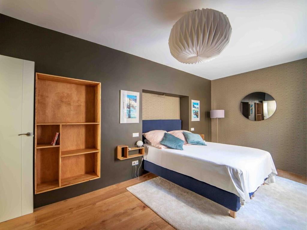 a bedroom with a large bed and a large ceiling at MyHouseSpain - Modern penthouse close to Gran Via - Big Terrace in Madrid