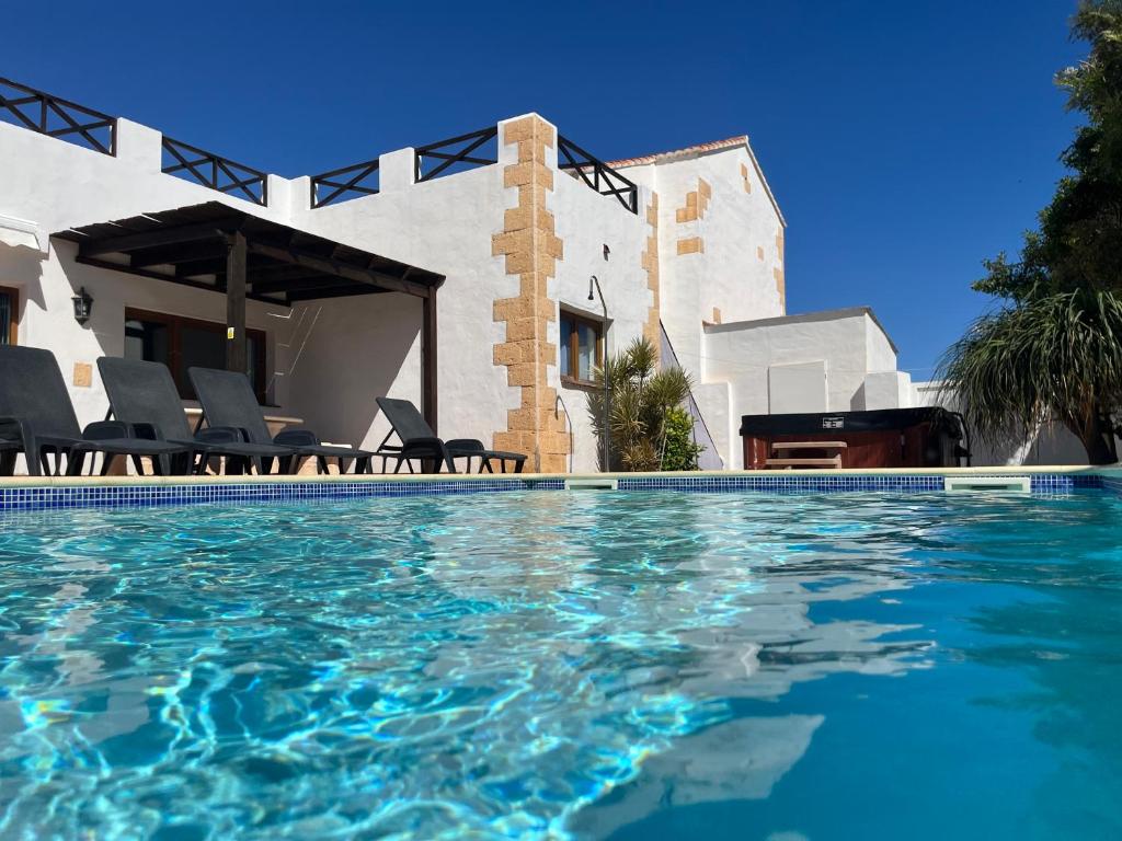 a swimming pool in front of a house at Casa Del Medio in Antigua