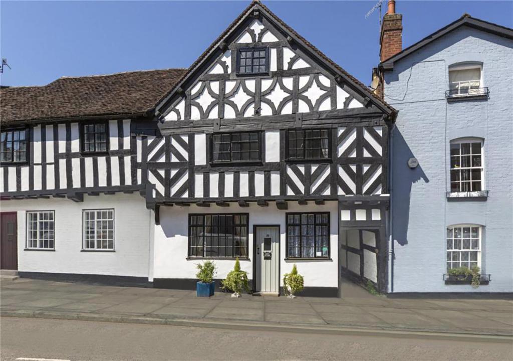 a black and white building with a white at Corve Cottage Historic cottage in beautiful ludlow in Ludlow