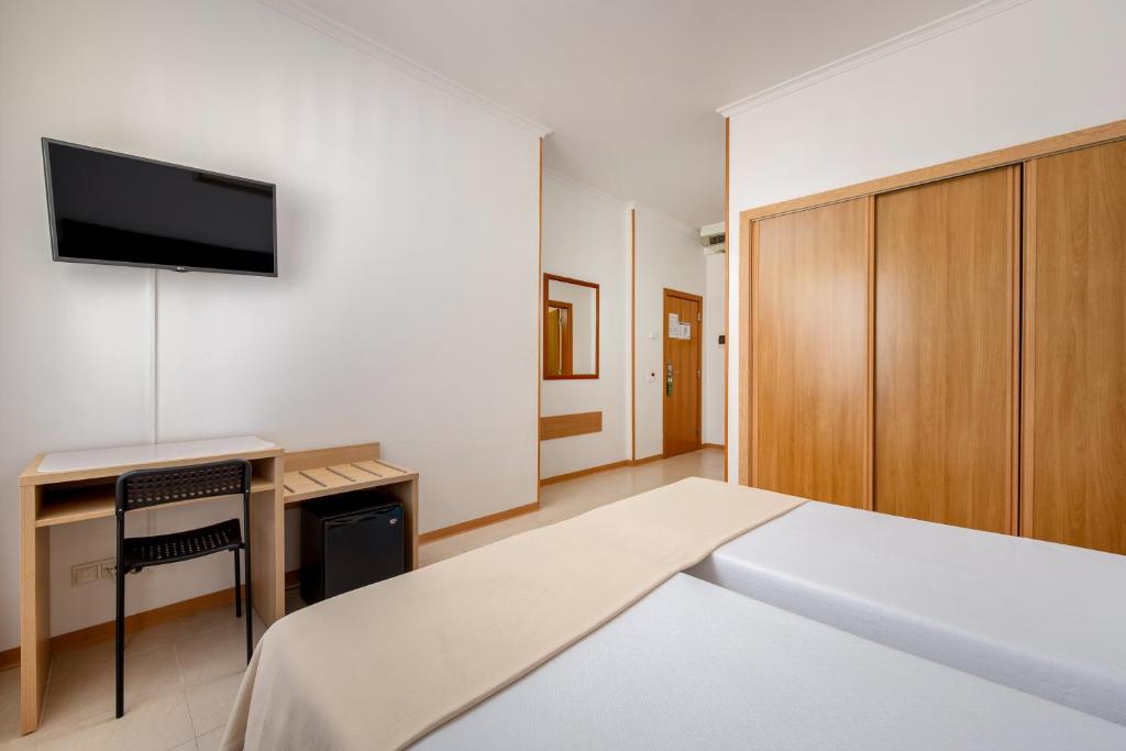 Een bed of bedden in een kamer bij Hotel Santa Catarina Algarve