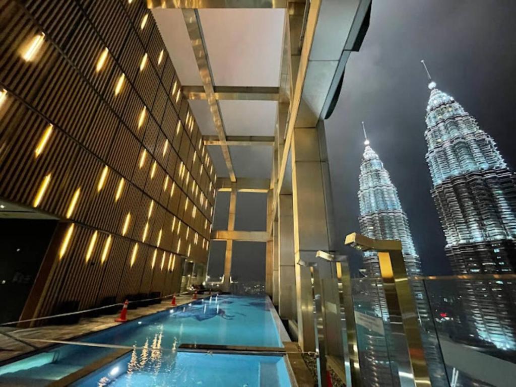 a view of the petronas twin towers from the rooftop of a building at Tropicana The Residence KLCC By Rainbow Suites in Kuala Lumpur