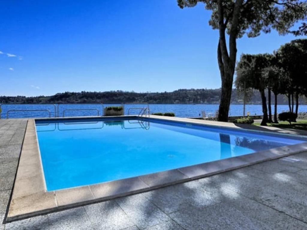 a swimming pool with a view of the water at Casa Vistabella in Salò