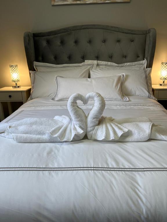 two swans making a heart on a bed at Horseleap BNB in Moate