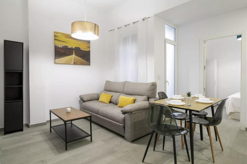 a living room with a couch and a table at Fantastic apartment in the heart of Alicante in Alicante