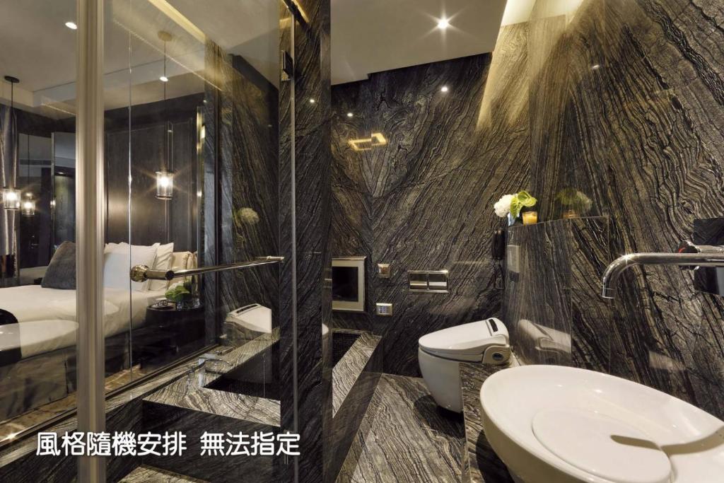 a bathroom with a shower and a toilet and a sink at Boda Hotel in Taichung