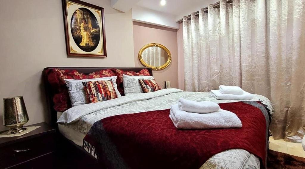 a bedroom with a bed with two towels on it at Classic House Hotel in Korçë