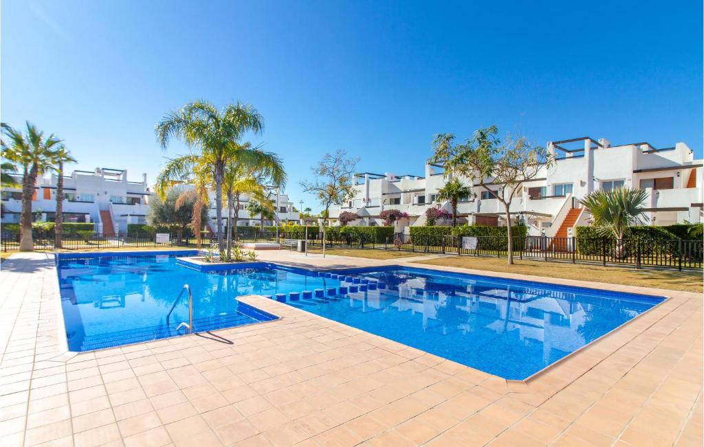 a swimming pool in front of some apartment buildings at Awesome Apartment In Alhama De Murcia With 3 Bedrooms, Wifi And Outdoor Swimming Pool in El Romero