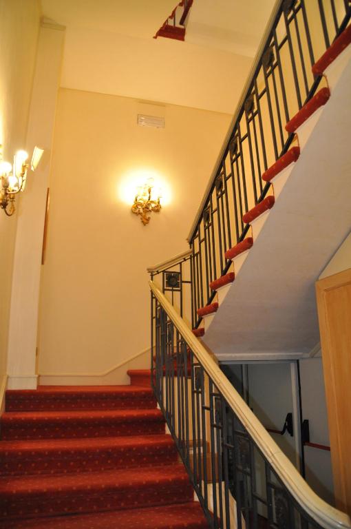 a staircase in a house with red carpeted stairs at Hotel Villa Laguna in Venice-Lido