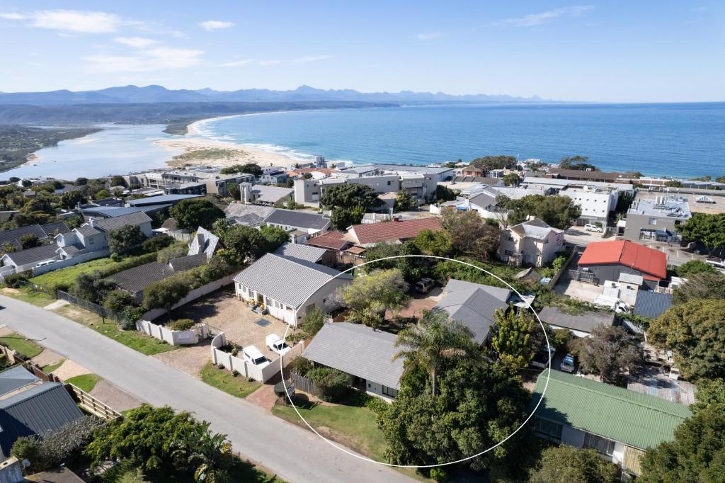 an aerial view of a small town with houses and the ocean at Nothando Backpackers Lodge in Plettenberg Bay