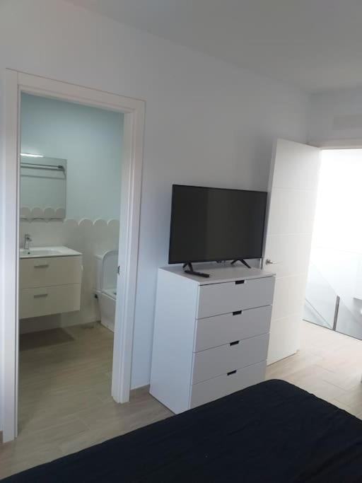 A television and/or entertainment centre at New luxury villa with jacuzzi in heart of Lanzarote
