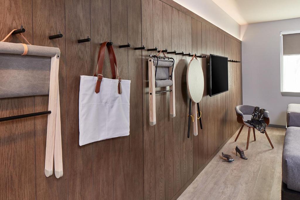 a room with a wooden wall with utensils on it at MOXY Denver Cherry Creek in Denver
