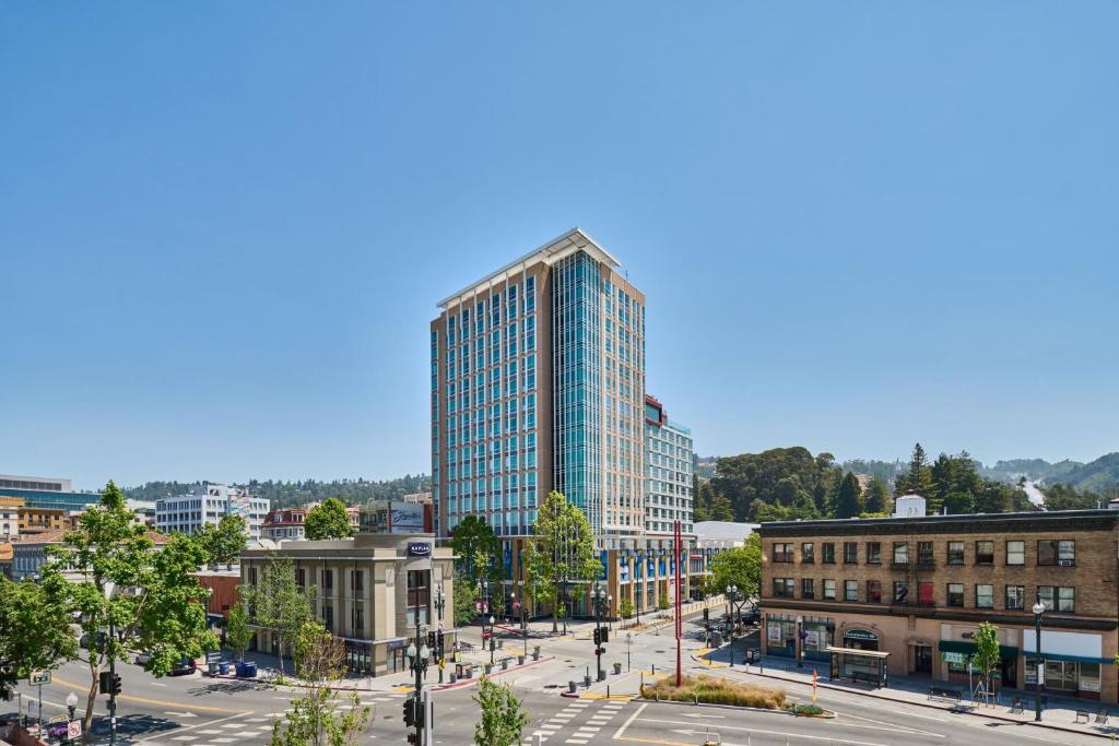 a tall glass building in the middle of a city at Residence Inn By Marriott Berkeley in Berkeley