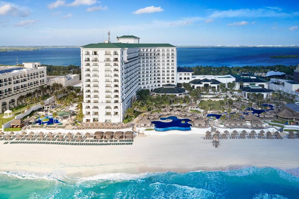 an aerial view of a resort with a beach and the ocean at JW Marriott Cancun Resort & Spa in Cancún
