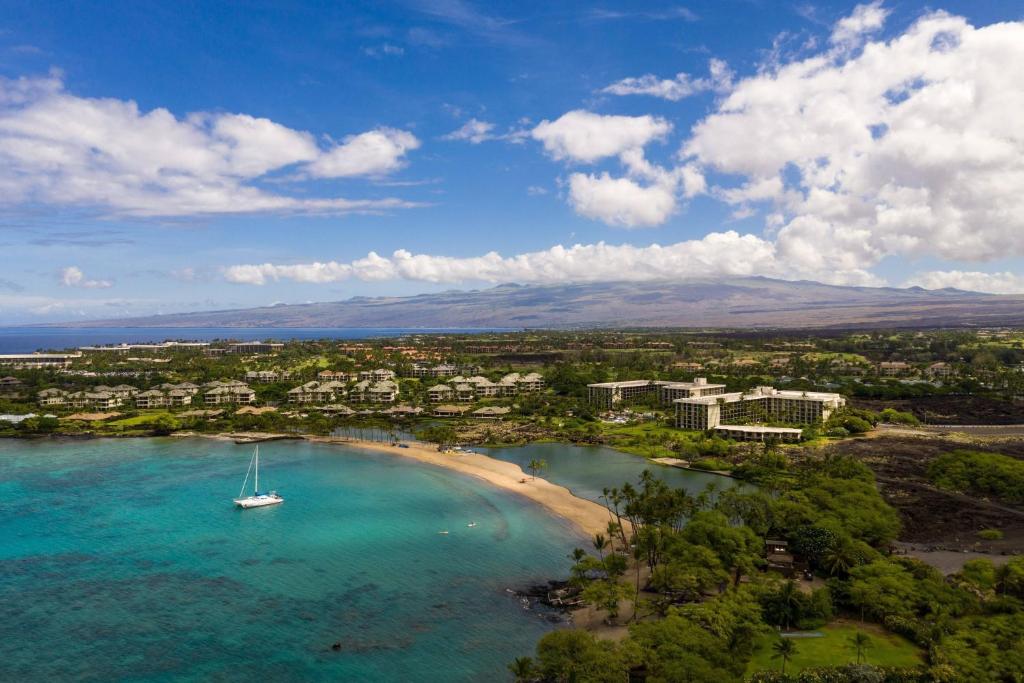 an aerial view of a beach with a boat in the water at Waikoloa Beach Marriott Resort & Spa in Waikoloa