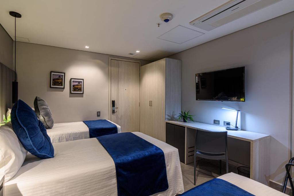 Postel nebo postele na pokoji v ubytování 4 Sur Hotel