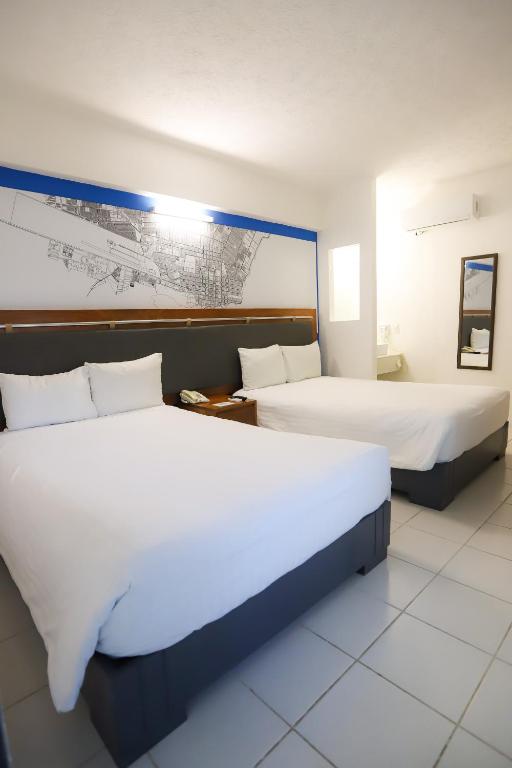 Postel nebo postele na pokoji v ubytování TRYP by Wyndham Chetumal