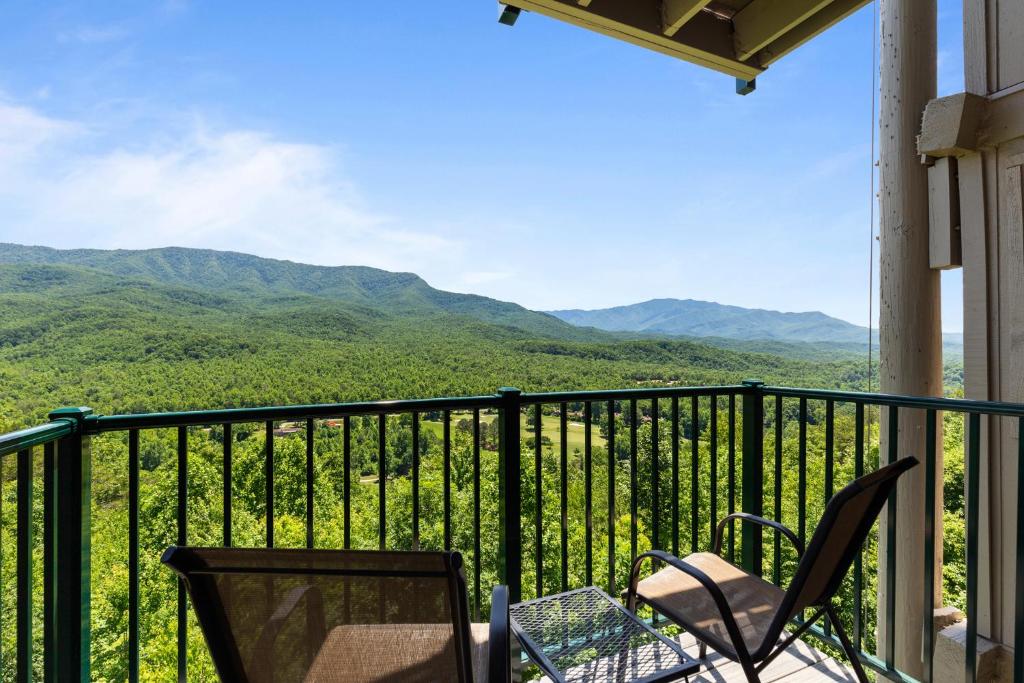 a balcony with chairs and a view of mountains at Deer Ridge Mountain Resort C202 in Gatlinburg