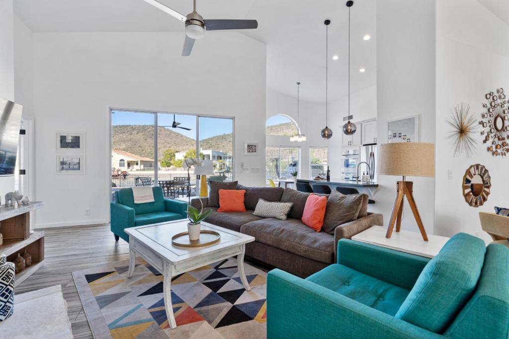 a living room with a couch and chairs and a table at Waterside - Lavish Lakeside Property with Heated Pool and Pontoon Boat in Peoria