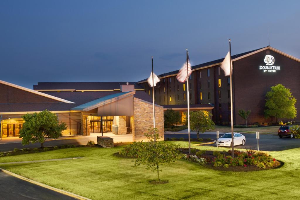 a hotel with flags in front of a building at DoubleTree by Hilton Collinsville/St.Louis in Collinsville