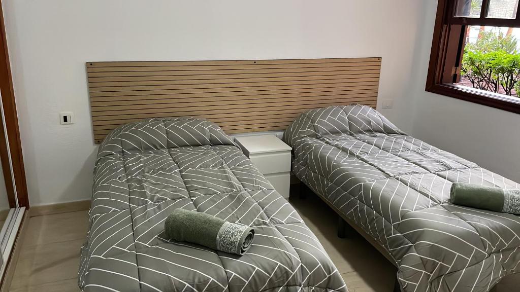 two beds sitting next to each other in a bedroom at Apartment South Tenerife in San Miguel de Abona