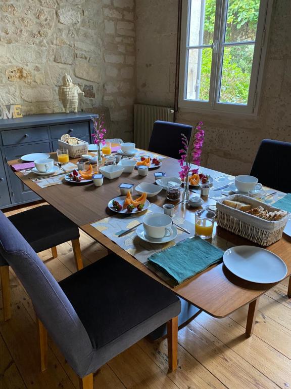 a wooden table with food on top of it at Le Clos des Grands Frênes in Pons