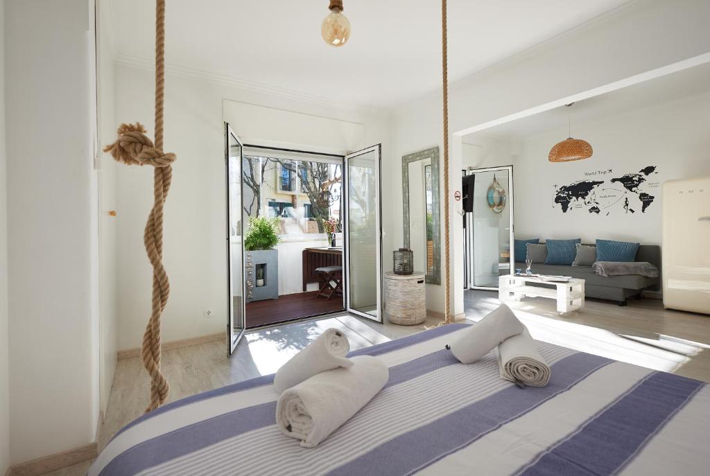 a bedroom with a large bed with pillows at Cozy Beach House São Pedro Estoril in São Pedro do Estoril