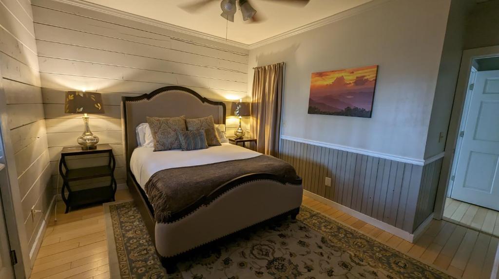 a bedroom with a bed and a lamp and a window at Barefoot Hills in Dahlonega