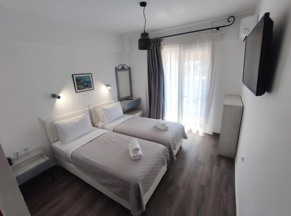 Postel nebo postele na pokoji v ubytování Syrtaki Hotel