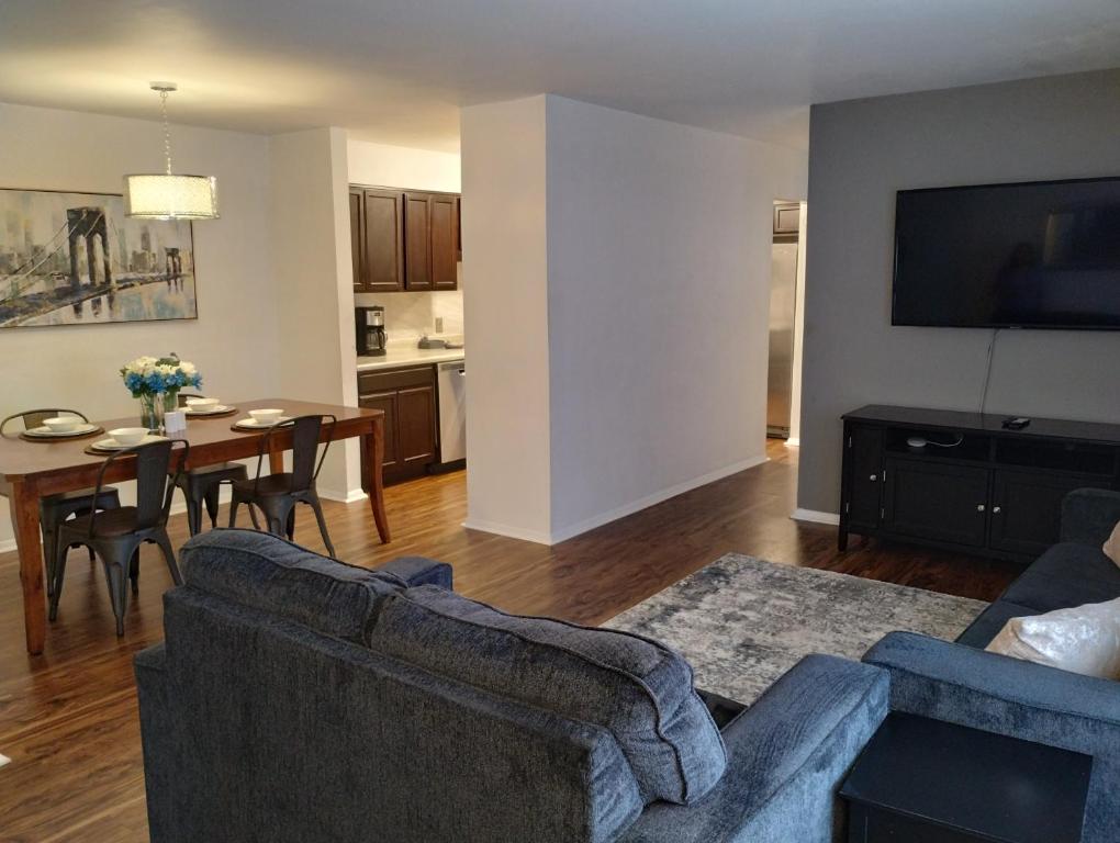 a living room with a couch and a table at Awesome Condo in Central Raleigh in Raleigh