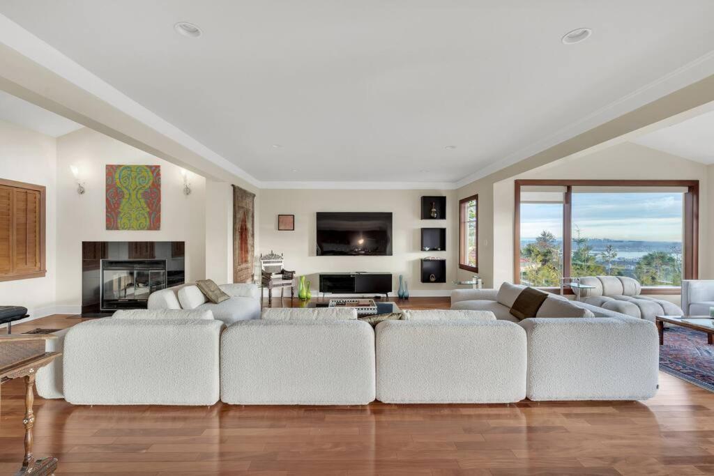 a living room with white furniture and a large couch at The West Vancouver Getaway Estate - 5 Bedrooms in West Vancouver