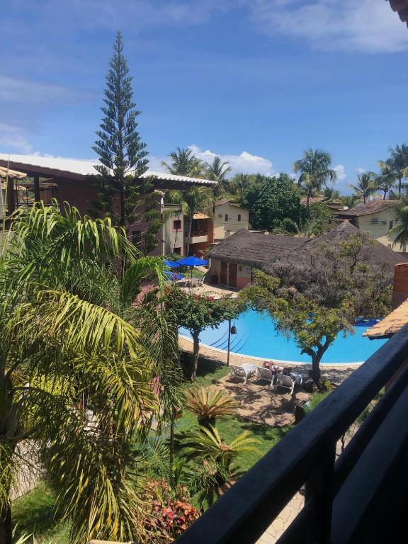 a view of the pool from the balcony of a resort at Resort Pipa Casa20 - Triplex maravilhoso in Pipa
