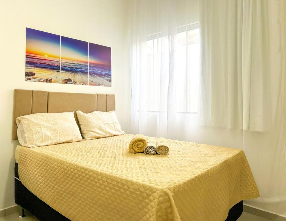 a bedroom with a bed with two shoes on it at Casa c WiFi e vista para o mar-Barra de São João RJ in Casimiro de Abreu