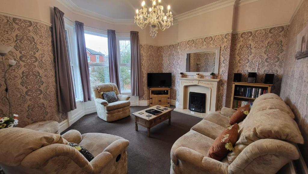 a living room with two couches and a fireplace at STAY - at Southport Holiday Home - sleeps 6 in Southport