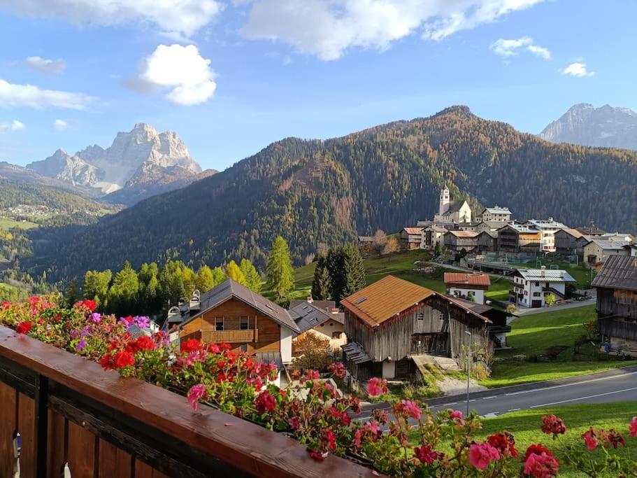 a view of a village with flowers on a balcony at Dolomia in Villagrande