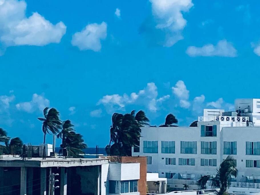 a white building with palm trees in front of it at Edificio Santa Catalina in San Andrés