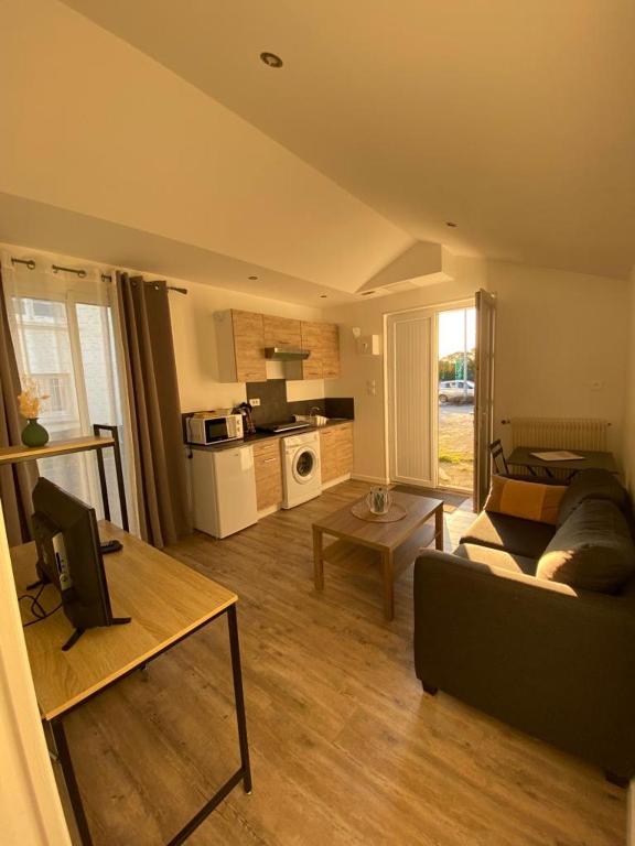 un salon avec un canapé et une table dans l'établissement Petit T2 proche centre ville, à La Roche-sur-Yon